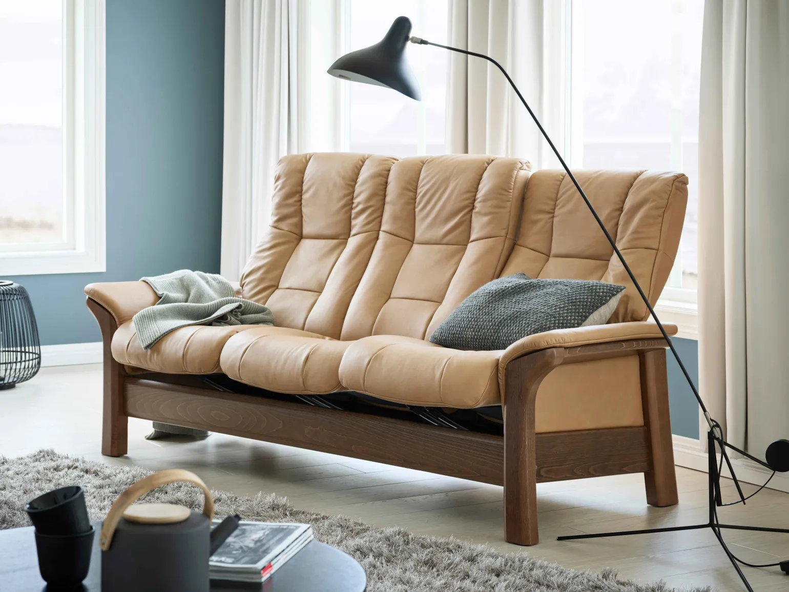 Timeless elegance meets modern functions with this beautifully cushioned, high-back sofa.
The Stressless Windsor and Stressless Buckingham are sofas that never go out of style, with their combination of soft cushions and beautiful wood.
Featuring the same design, you can choose from Stressless Windsor which is based on a medium sized seat or Stressless Buckingham which features a wider seat. They also have the Plus™-system, which means that the sofa follows your movements and provides good support in all sitting positions.
Available as a 3 Seater, 2 Seater or Chair with a wide choice of premium leathers, fabrics and wood finishes, the Windsor brings pure, classic comfort to any living space.